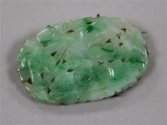 A Chinese white metal mounted carved jadeite brooch, 50mm.